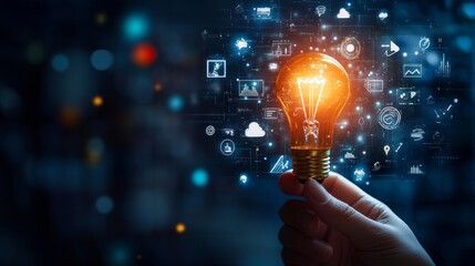 Hand holding light bulb with digital icons and network connection on blue background, representing innovation in technology for business or education. High quality, professional photography