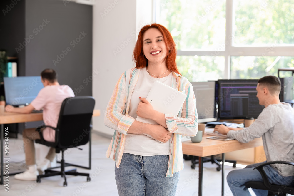 Canvas Prints Young female programmer with laptop in office