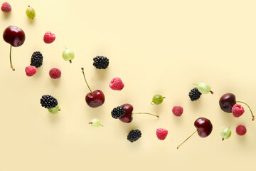 Different berries flying on beige background