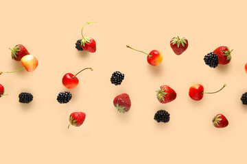 Different berries flying on beige background
