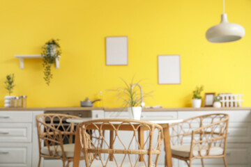 Blurred view of kitchen with white counters and dining table