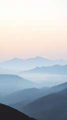 Tranquil and Mystical Mountain Scene at Dawn with Mist Shrouded Peaks, Soft Sky, and a Serene Atmosphere of Wonder