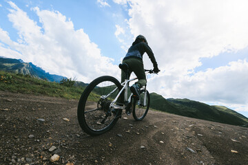 Woman riding mountain bike in the beautiful mountains