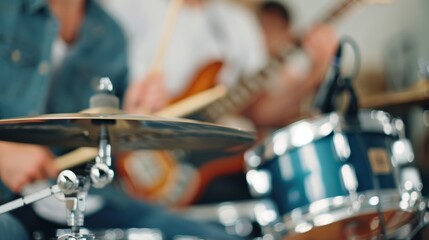 A group of musicians passionately playing guitar and drums, showcasing their musical talents in a lively performance setting with blurred focus on the instruments.
