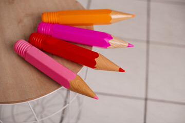 A collection of large, colorful pencils, ideal for decorating classrooms or creative workspaces.