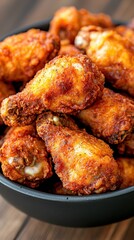 A bowl brimming with crispy, golden-brown fried chicken pieces.

