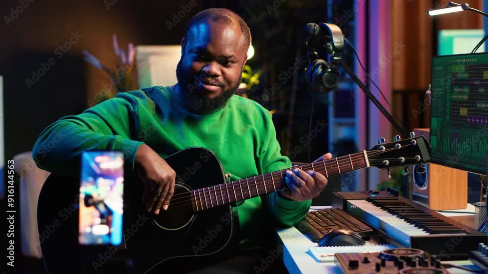 Poster guitarist instructor hosting guitar lessons online using a mobile phone, recording tutorial for mast