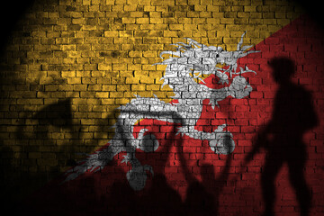 bhutan flag painting on brick wall and Protesters shadow