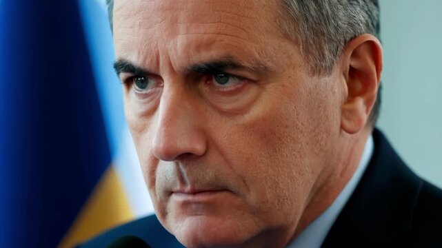 The camera focuses on the spets determined expression as they handle a potentially challenging question from the media at a press briefing.