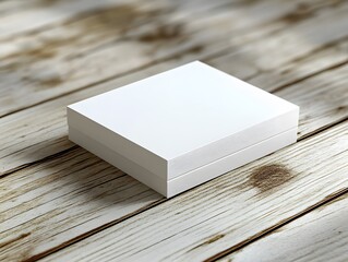 Fototapeta premium White business card mockup on a light wooden surface, with a subtle texture in the background