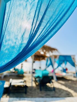 Close-up of a blue curtain on a sun loungers on beach, Thassos, Aegean islands, Greece