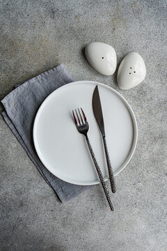 Overhead view of a Minimalistic place setting with salt and pepper cellars on a table