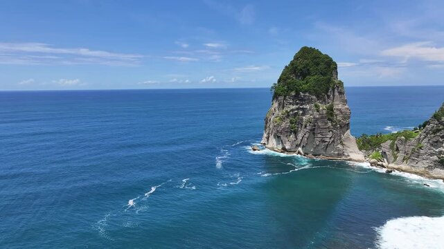 Aerial view of beautiful beach with rice fields and blue sea against the backdrop of large cliffs, Pangasan Beach, Pacitan Regency