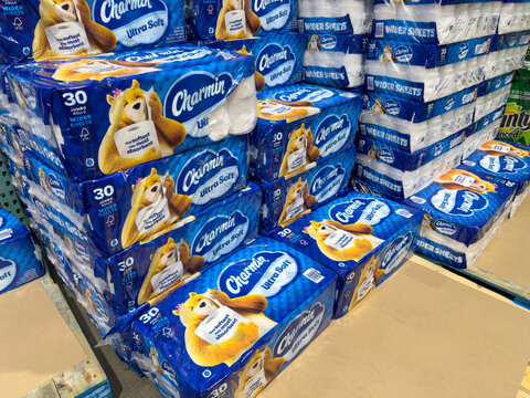 Large packs of Charmin brand of toilet paper on display inside Costco warehouse.