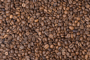 Roasted coffee beans as a background. Macro photo of coffee. Arabica.