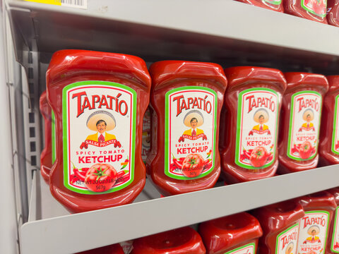 Bottles of Tapatio brand spicy ketchup on market shelf.