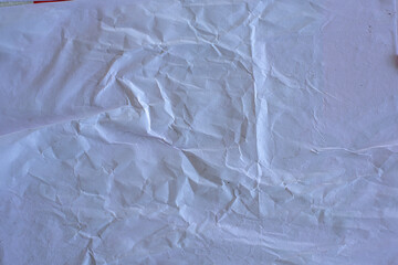 White paper poster mockup isolated on black background. Blank glued creased paper sheet texture