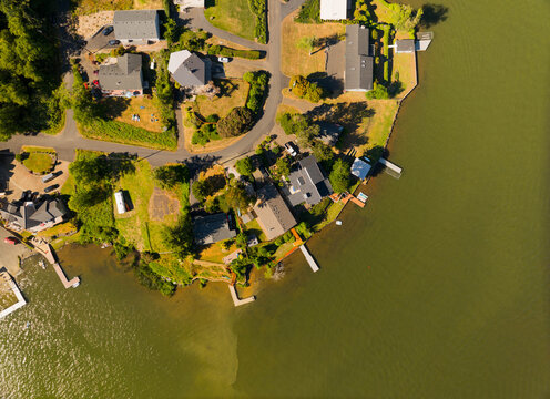A view of a lake with houses and docks in the background