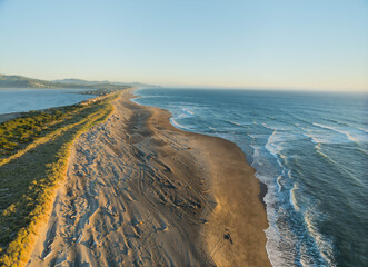 The ocean is calm and the beach is sandy