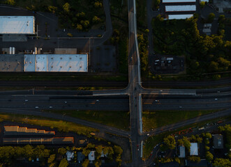 A city street view with a large overpass and a few cars