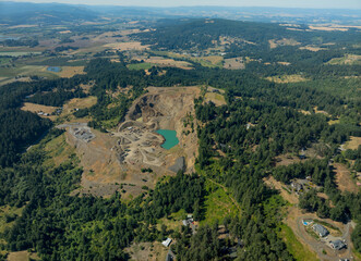A large open field with a green lake in the middle