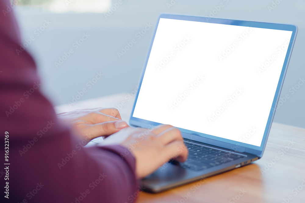Poster Mockup image of adult man using and typing on laptop on table in the cafe.