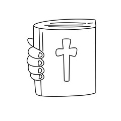 A hand is holding a book with a cross on it