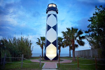 Lighthouse at sunset overlooking the sea on a boardwalk near Houston Texas on a summer day