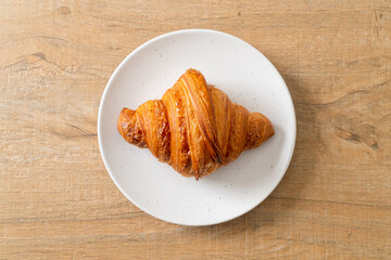 fresh croissant on white plate