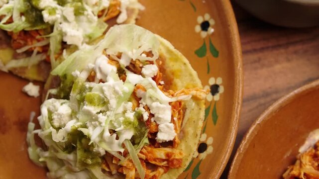 Corn toasts, chicken tinga, lettuce, sour cream, beans and green sauce