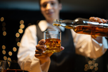 Barman pouring whiskey whiskey glass beautiful night