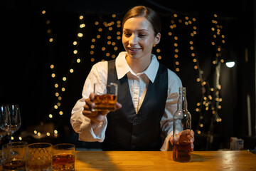 Barwoman pouring whiskey whiskey glass..