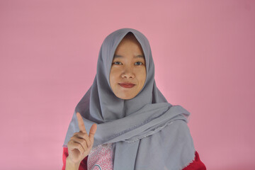 Portrait of a confident Asian woman facing the camera on an isolated background