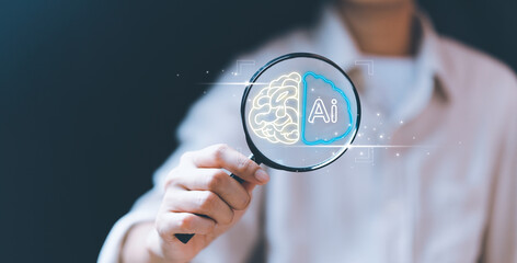 businessman,holding magnifying glass,digital touch screen, hemispherical brain icon,representing...