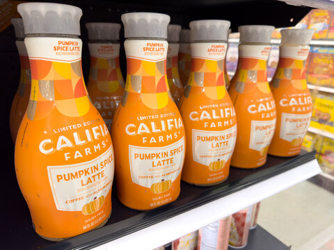 Bottles of Califia Farms Pumpkin Spice Latte drinks on market shelf.