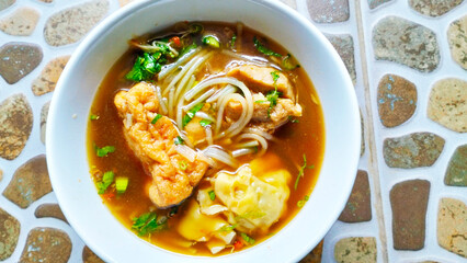 meatballs with spicy soup ,sprinkled with sliced celery leaves