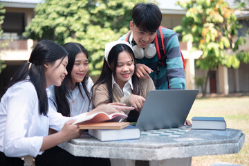 Group of students studying on campus outdoors