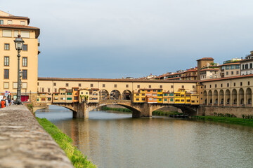 Florence, Italy. Ponte Vecchio - Medieval arched bridge with souvenir and jewelry shops. Summer day