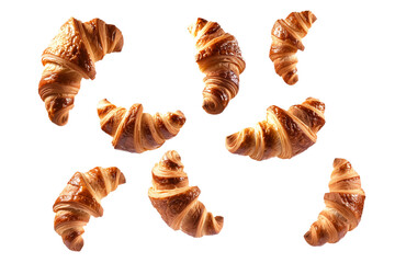 A variety of golden croissants for breakfast flying and isolated on white transparent background. Flaky and buttery goodness awaits