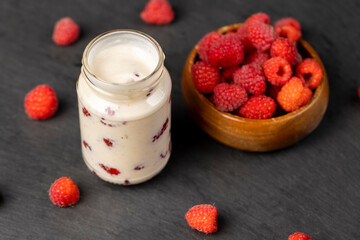 delicious and fresh yogurt with raspberry flavor and whole red raspberries
