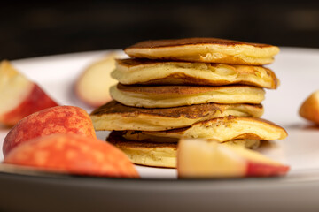 milk pancakes with butter and sliced peach slices