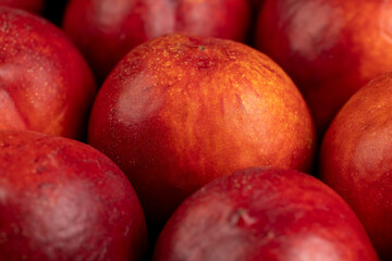 a large number of ripe soft nectarine fruits on the table