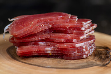 sliced ham with bacon on a board