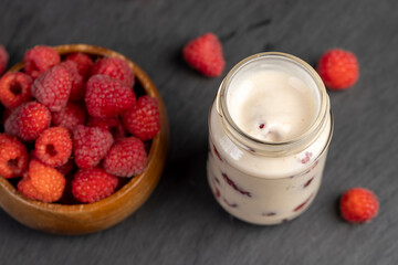 delicious and fresh yogurt with raspberry flavor and whole red raspberries