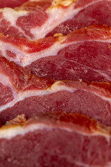 a piece of cured pork ham with thin layers of lard