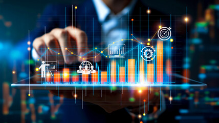 A business professional interacts with a digital screen displaying financial analytics and growth charts. The image highlights the use of advanced technology in business analysis and decision-making.