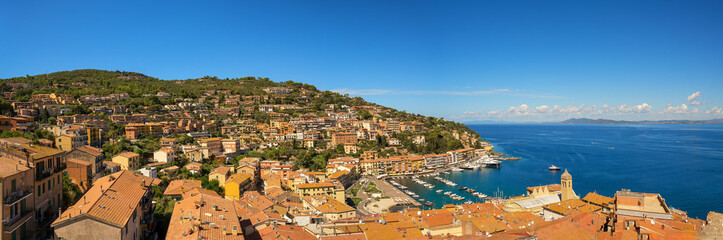 Obraz premium Beautiful panoramic view from above of the bay and the port of Porto Santo Stefano. Municipality of Monte Argentario, Grosseto. Copy space.