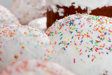 Flour pastries with white icing and colorful balls