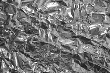Processed collage of shiny metal silver gray foil crumpled packaging material texture