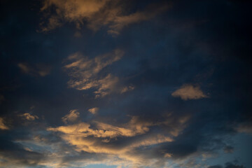 The evening sky. The setting sun illuminated the clouds. The light on the clouds.